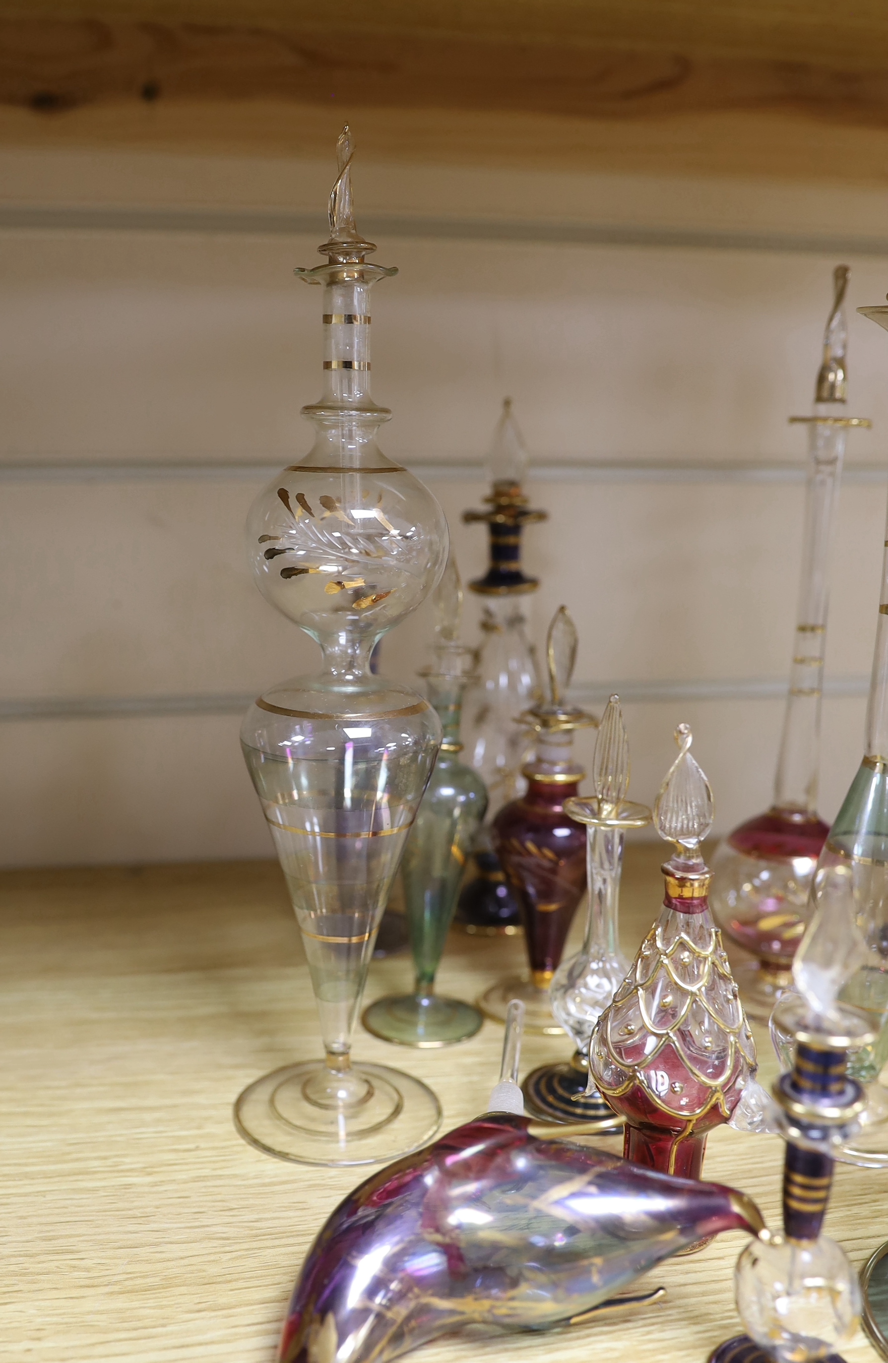 A collection of gilded glass scent bottles and stoppers, 27cm